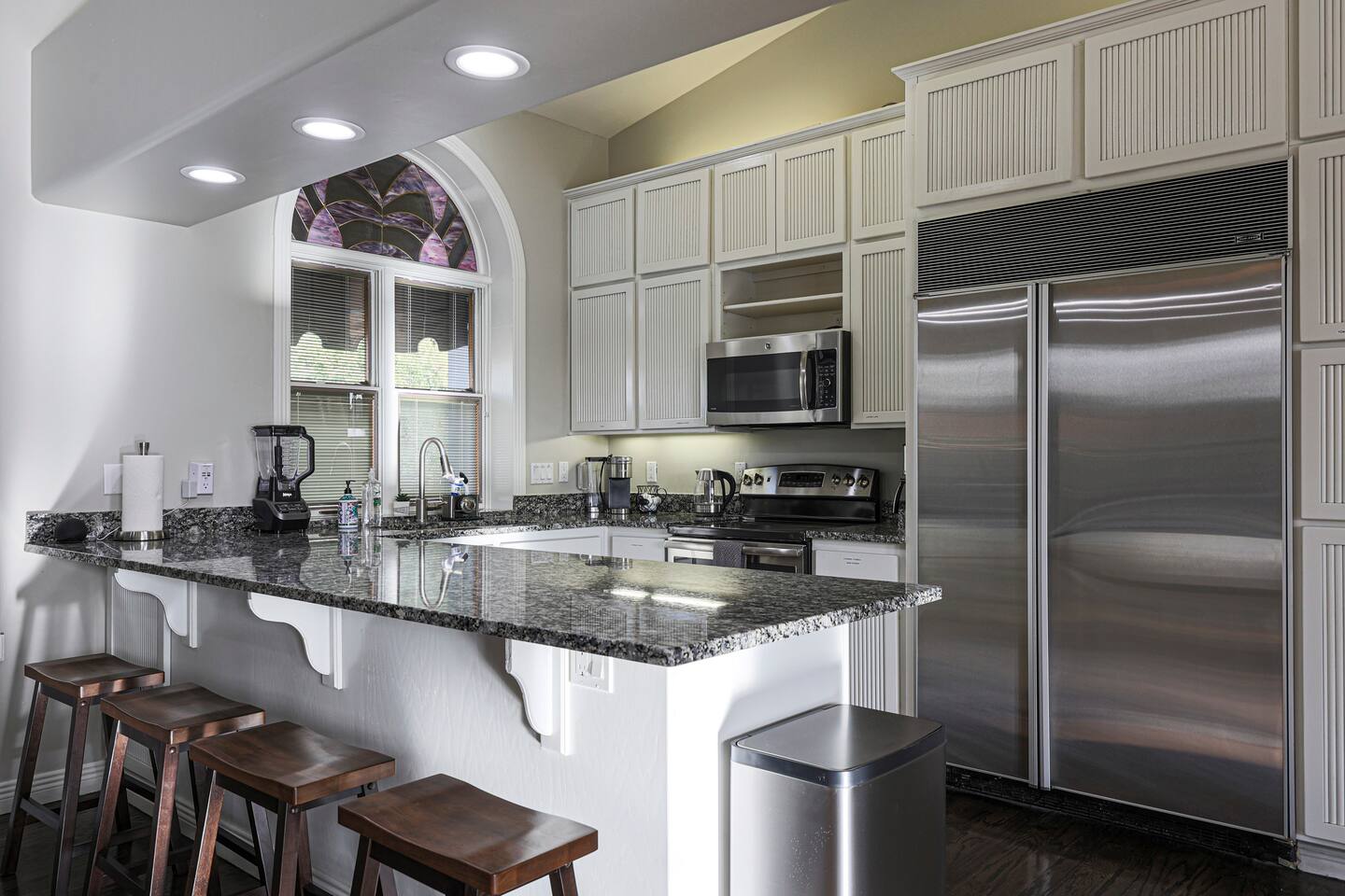 This chef’s kitchen blends modern utility with upscale charm—featuring granite countertops, premium stainless steel appliances, and a spacious breakfast bar perfect for casual bites or morning coffee.