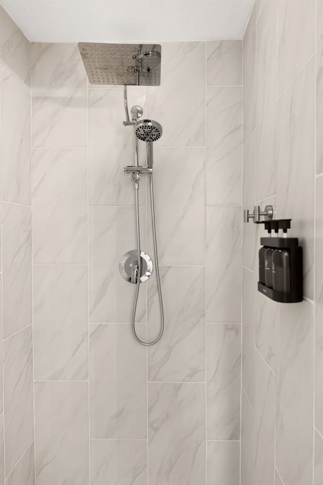 The walk in shower features a rainfall shower head, a hand held shower head and complimentary shampoo, conditioner and body wash.