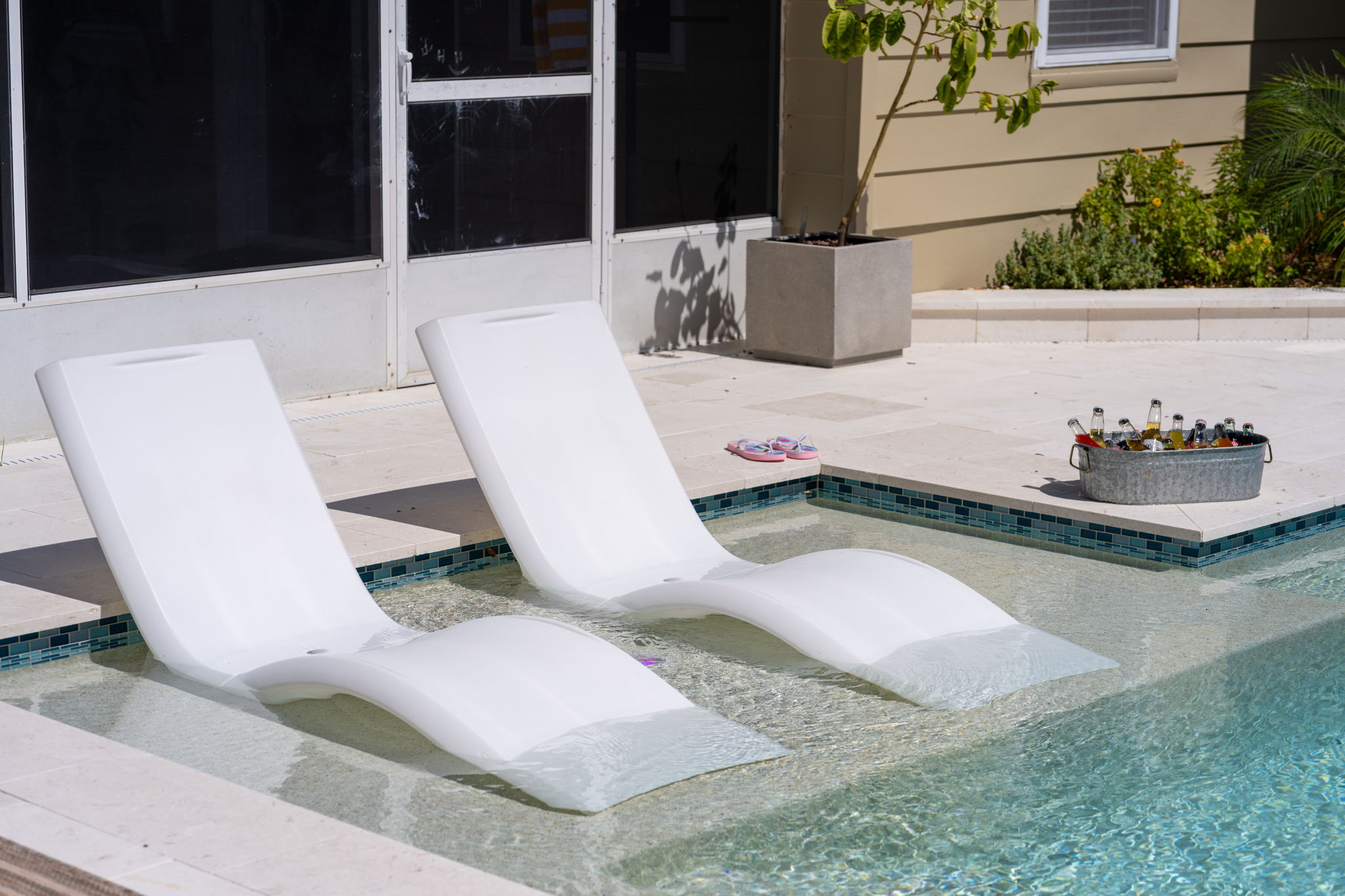Framed by tropical plants and stylish decor, this pool is the ultimate Instagram-worthy hangout.