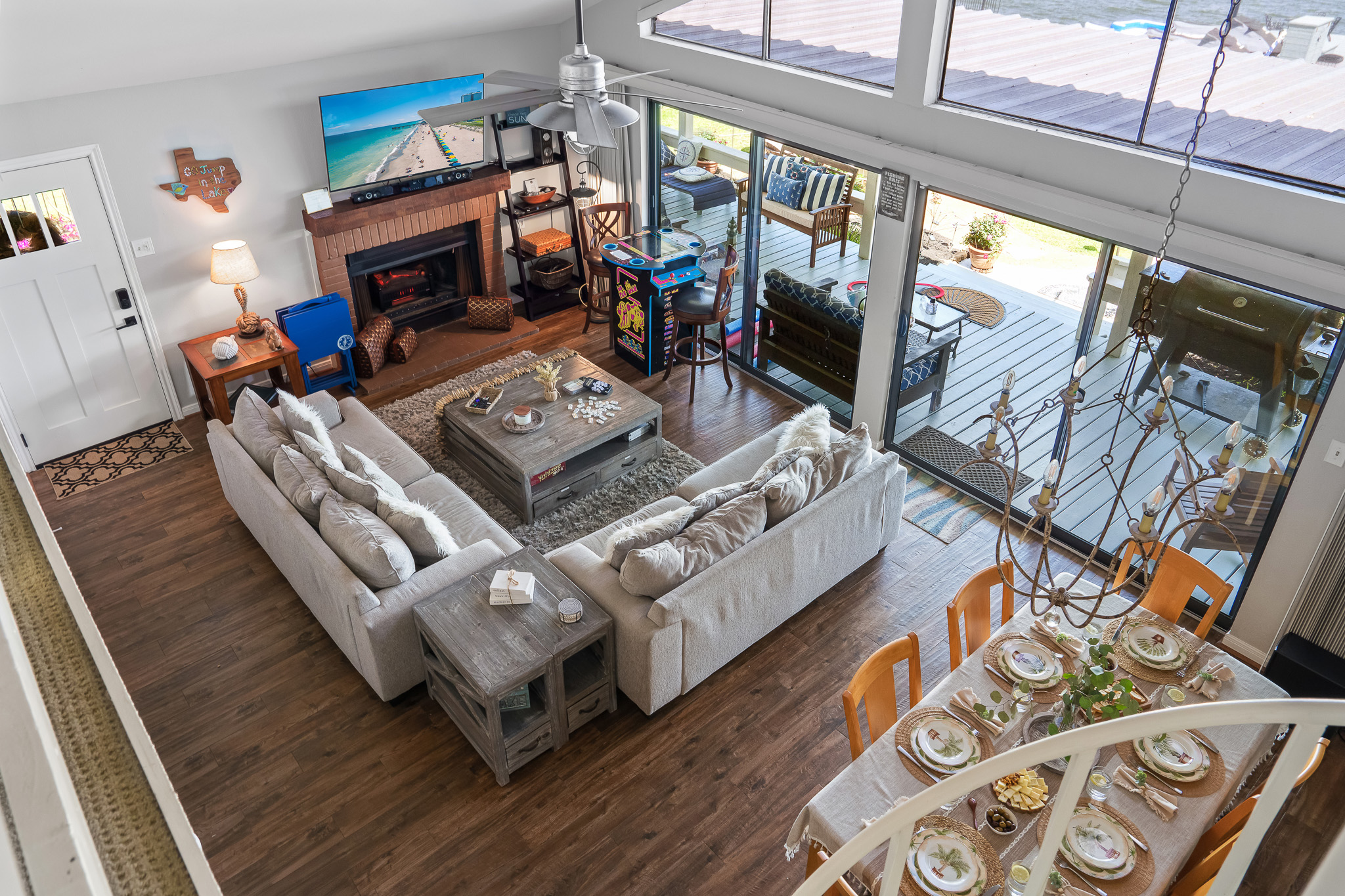 Step into this inviting lakeside retreat where movie nights, game battles, and cozy conversations come to life. With a spacious living room, classic arcade fun, and seamless indoor-outdoor flow to the deck, it’s the perfect place to relax, and reconnect. 