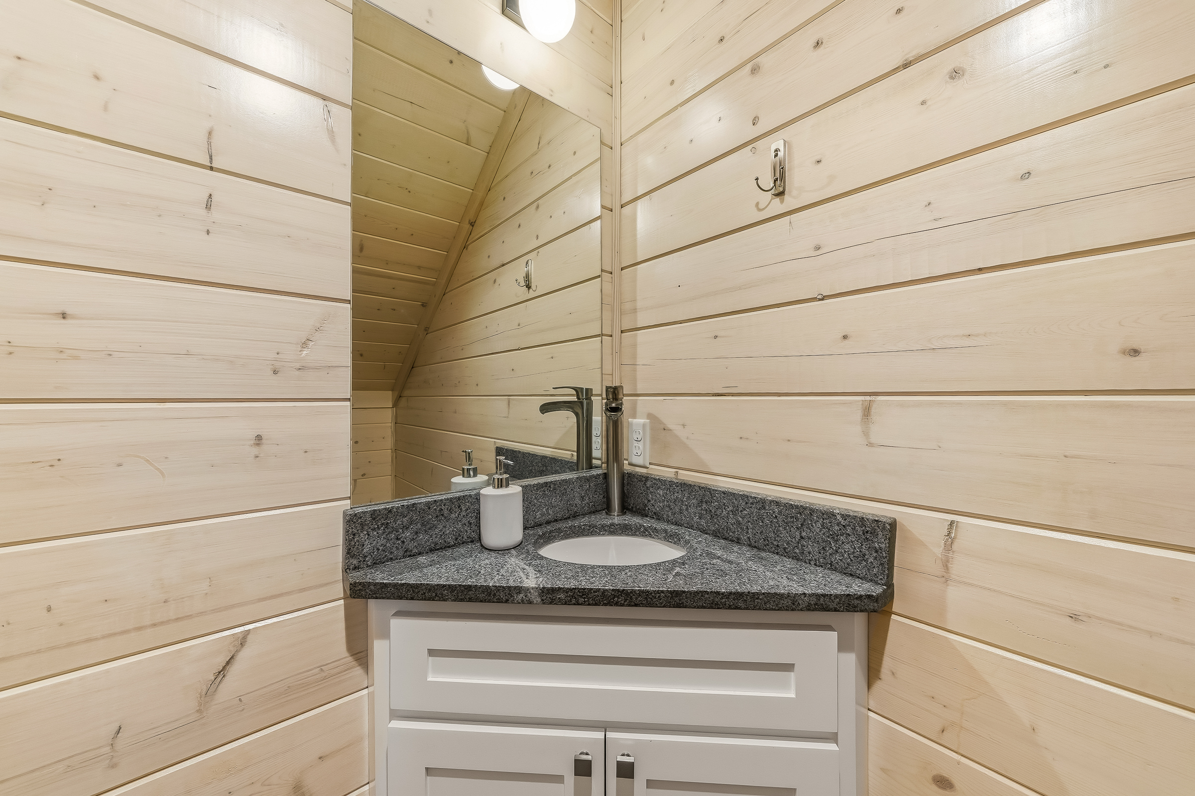 A bright, thoughtfully designed half bath with modern fixtures and clean lines, perfect for quick refreshes during the day. Tucked in a convenient spot, it keeps everyone comfortable without ever feeling crowded.