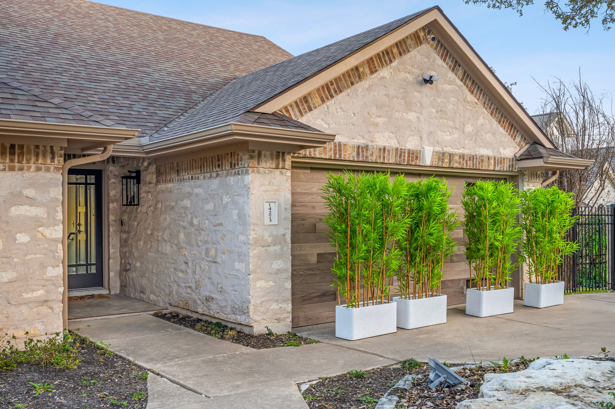 Charming front entry with beautiful stone exterior and welcoming curb appeal.