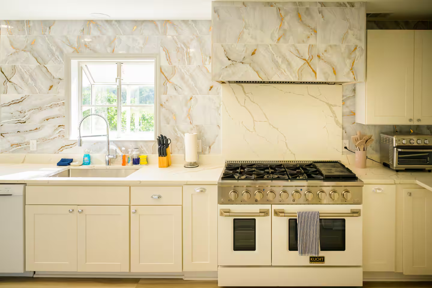 Cook like a pro with this luxury 48” gas range and designer marble backsplash.