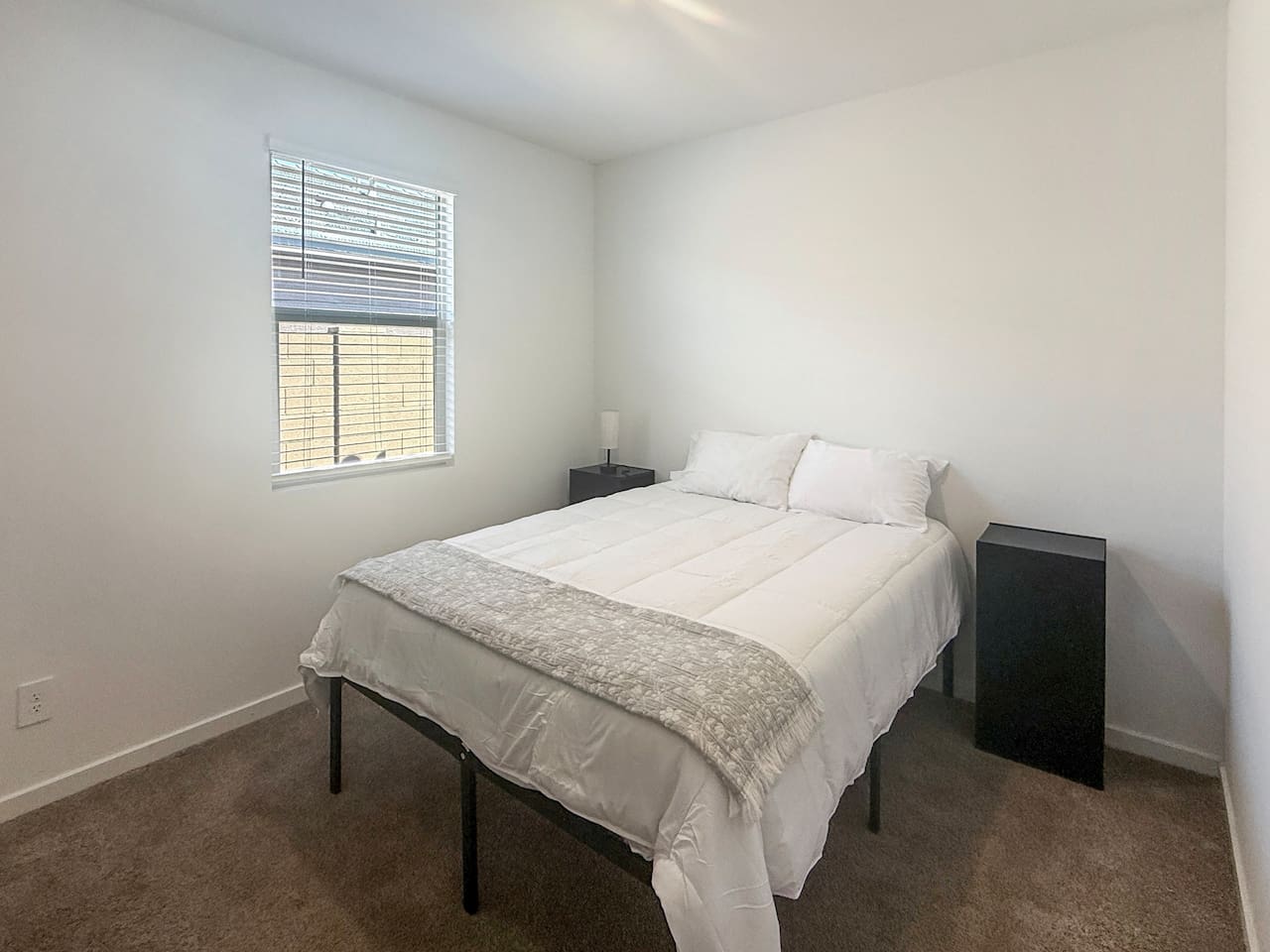 Bedroom with bed, nightstand, and window