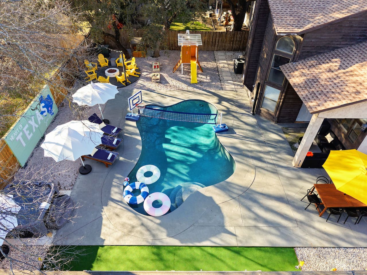 A backyard built for memories—private pool, volleyball, fire pit, hot tub, outdoor dining, and a kids’ play area, all wrapped in fun & Texas flair. Perfect for your group’s getaway