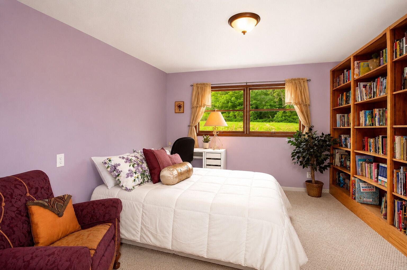 A cozy queen bedroom with built-in bookshelves, perfect for relaxing and unwinding with a good book.