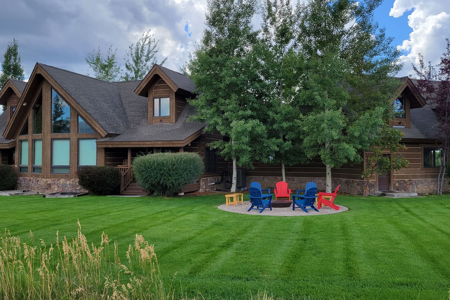 Unwind in the expansive backyard with a dedicated fire pit gathering area, complete with Adirondack chairs and surrounded by lush green space—perfect for relaxing evenings under the open sky.  Great for morning coffee, too!
