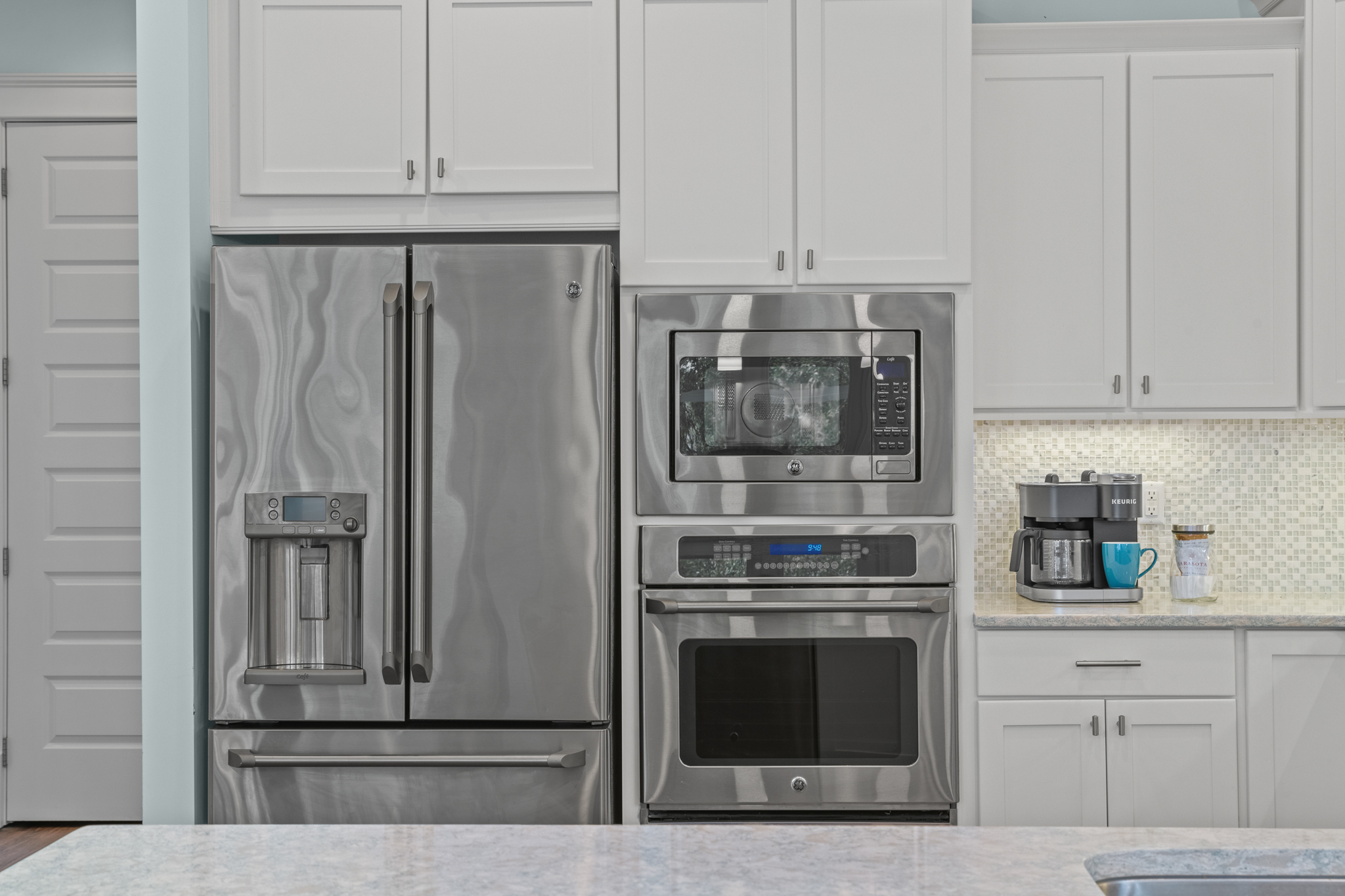 The kitchen boasts stainless steel appliances and granite countertops.