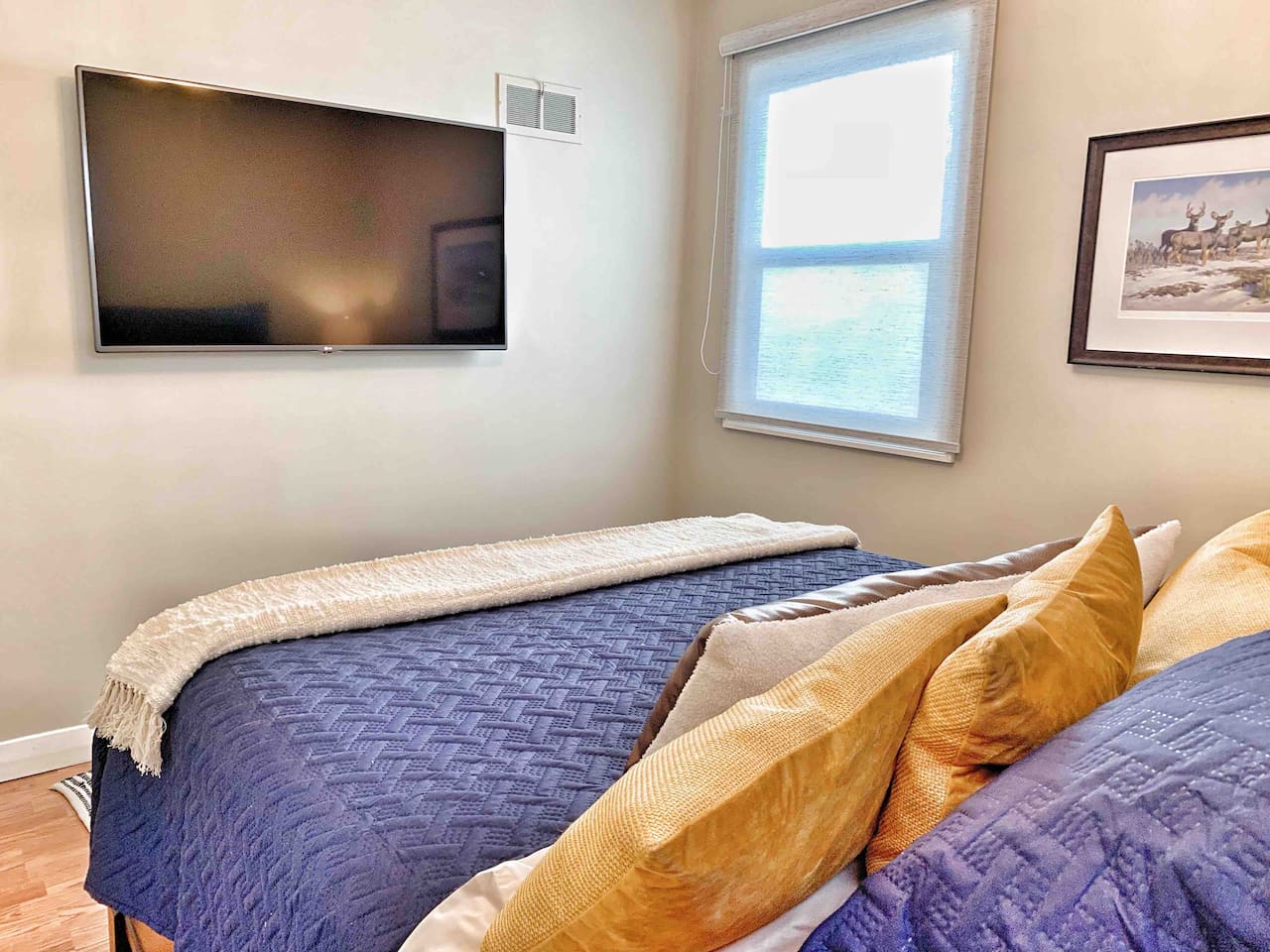 Primary Bedroom with Queen Bed & 55″ Smart TV