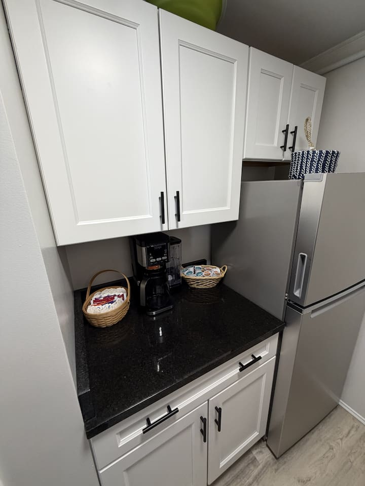 Coffee station and fridge.