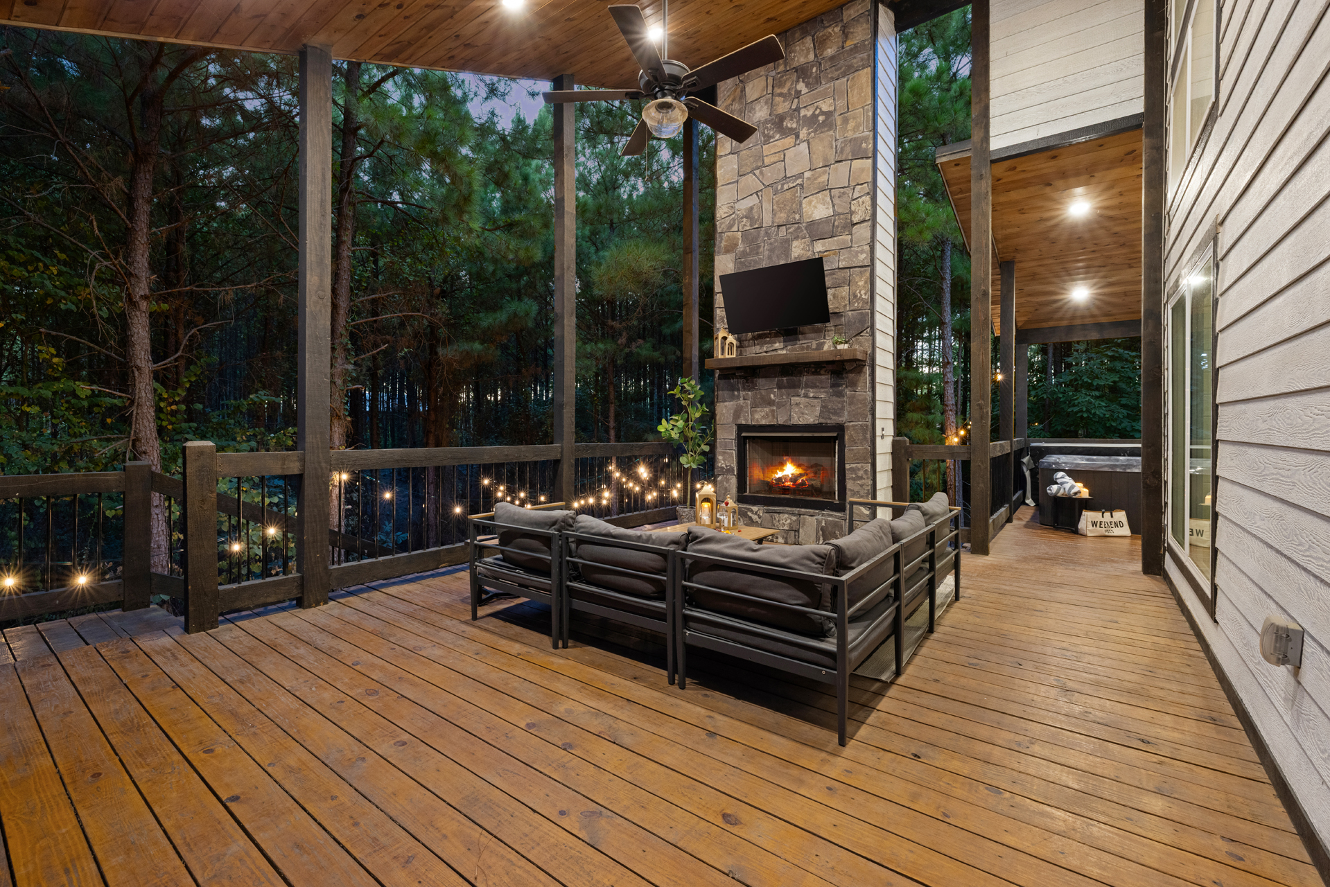 Your outdoor living room, wrapped in the pines under covered deck. Curl up by the fireplace for a movie or quiet night together, with the hot tub just steps away and nothing but forest beyond the deck.