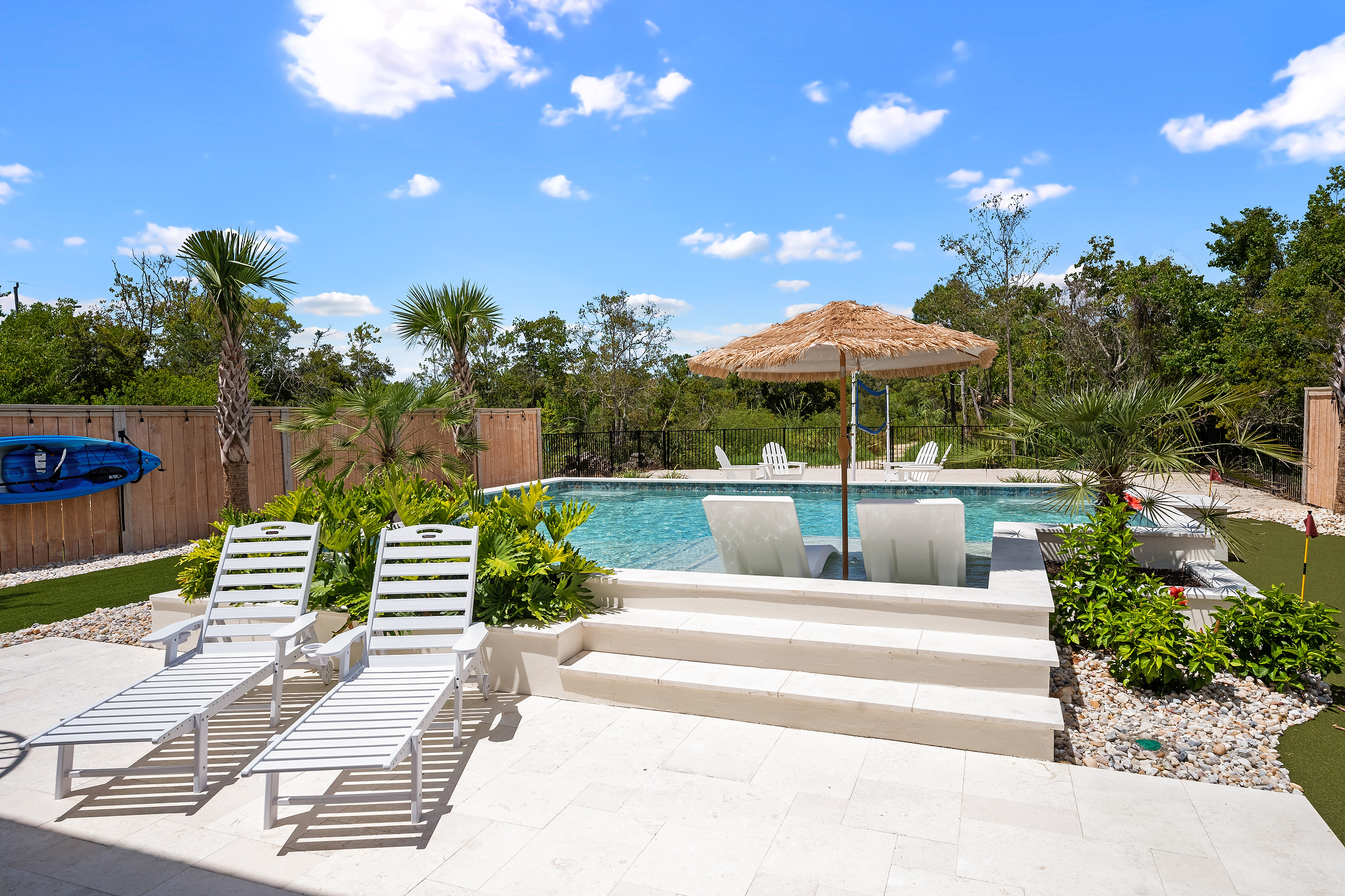 Plenty of poolside space for lounging between swims and backyard games.