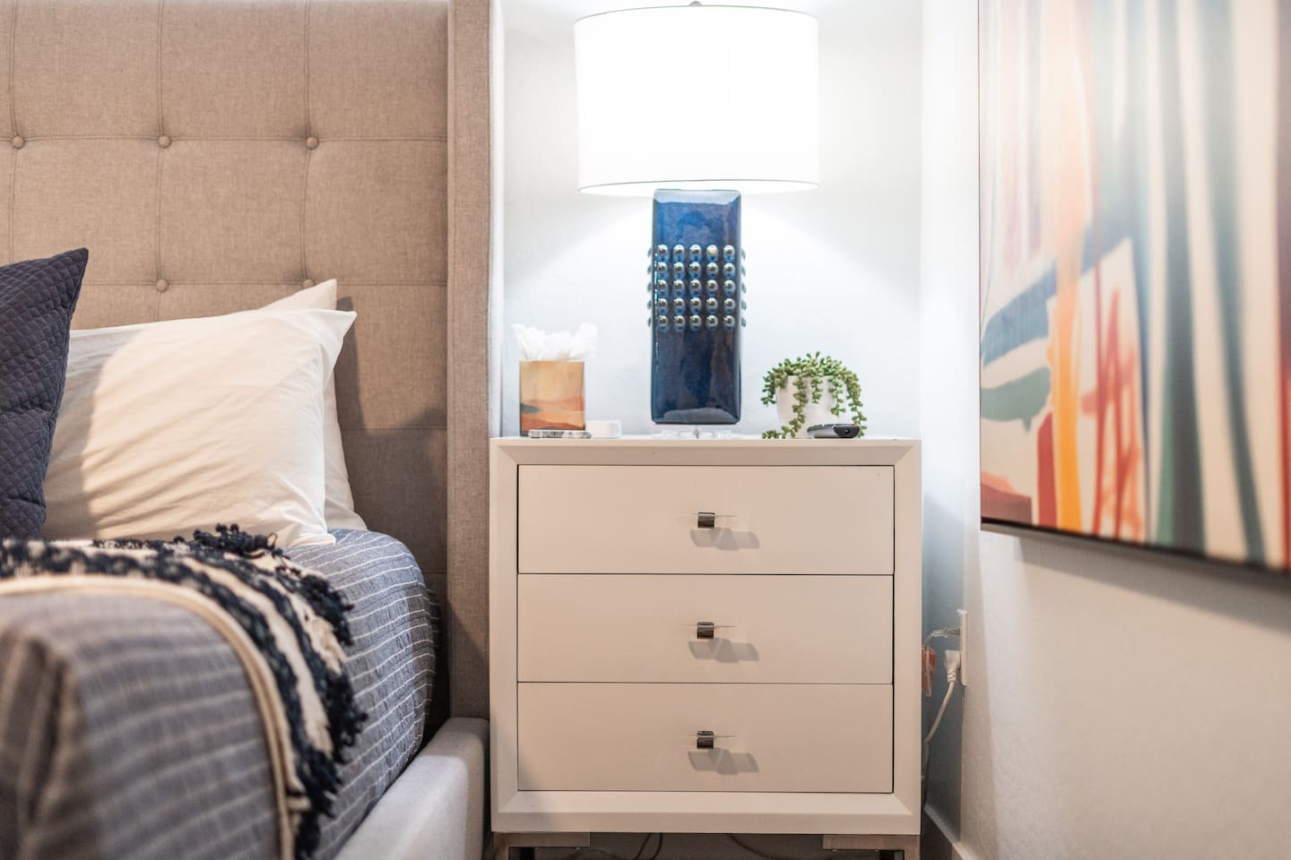 Elegant bedside cabinet featuring a sleek lamp, providing both style and functionality to the bedroom.