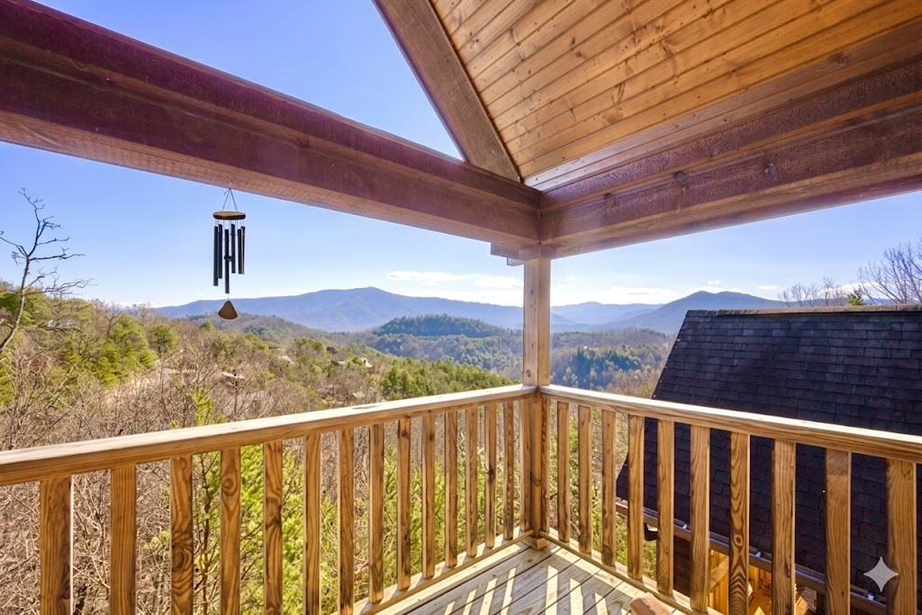 Step out onto the balcony and let the mountain air refresh your spirit. The gentle sound of the wind chime and panoramic Smoky Mountain views make this the perfect spot to unwind at sunset.