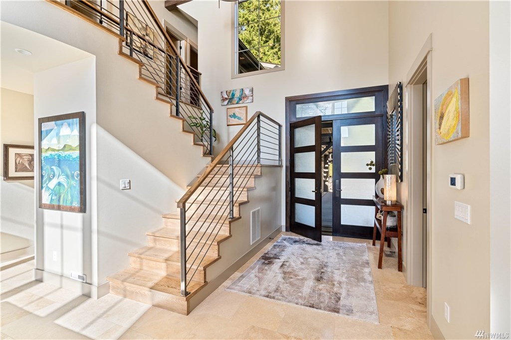 Welcoming front entry with elegant stairs to the second floor.
