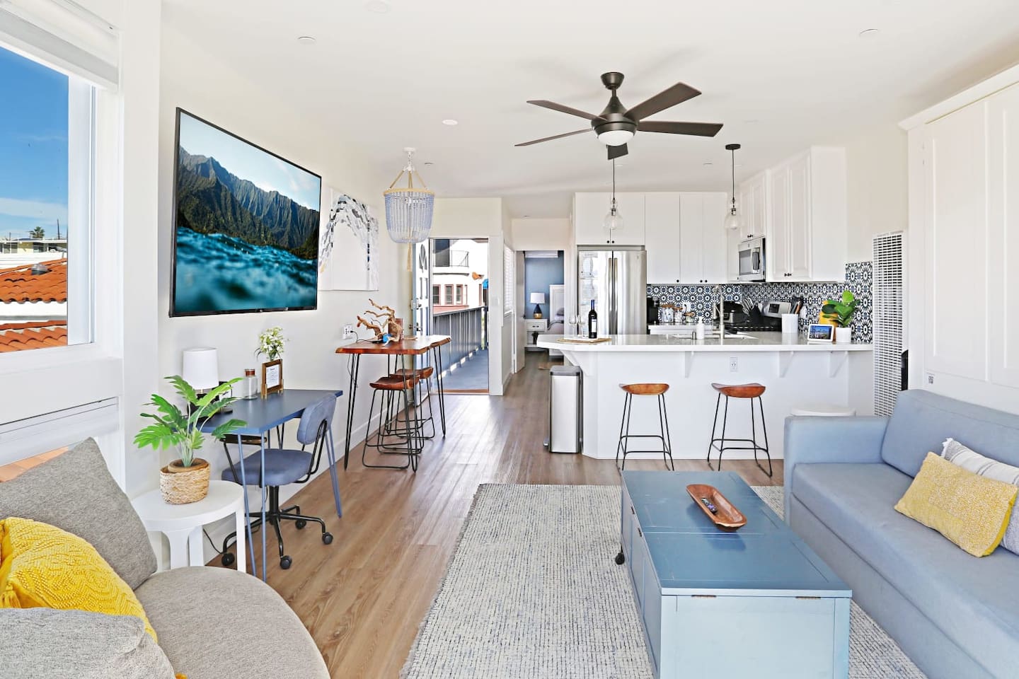The open floor plan enables everyone to feel included even during meal prep :)  There is seating for four at the table along the left side but also a breakfast bar and seating on the balcony.