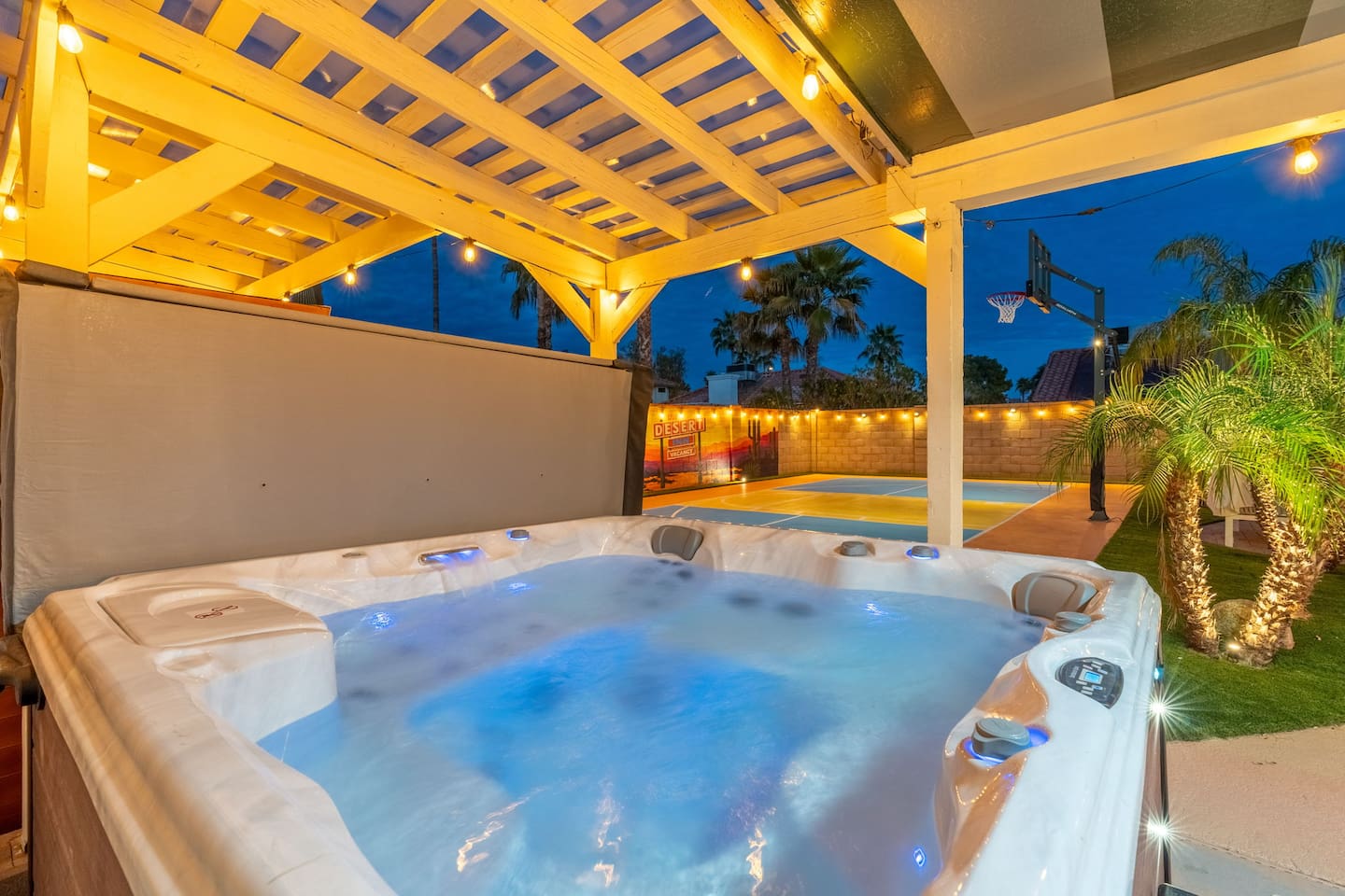 Spa-like hot tub under the stars — your private resort escape with views of the grounds and palm-lined landscape.