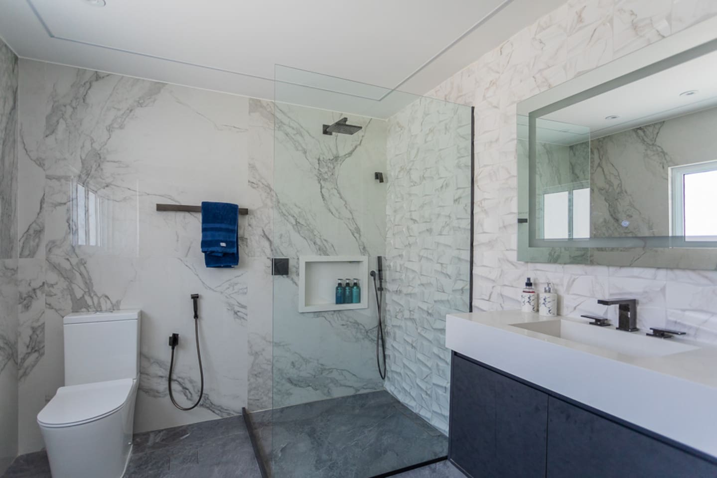 Ultra modern new bathrooms with designer lighting.  In addition to overhead lighting, many bathrooms have lighting embedded in mirrors that are activated by pressing button on mirror. 