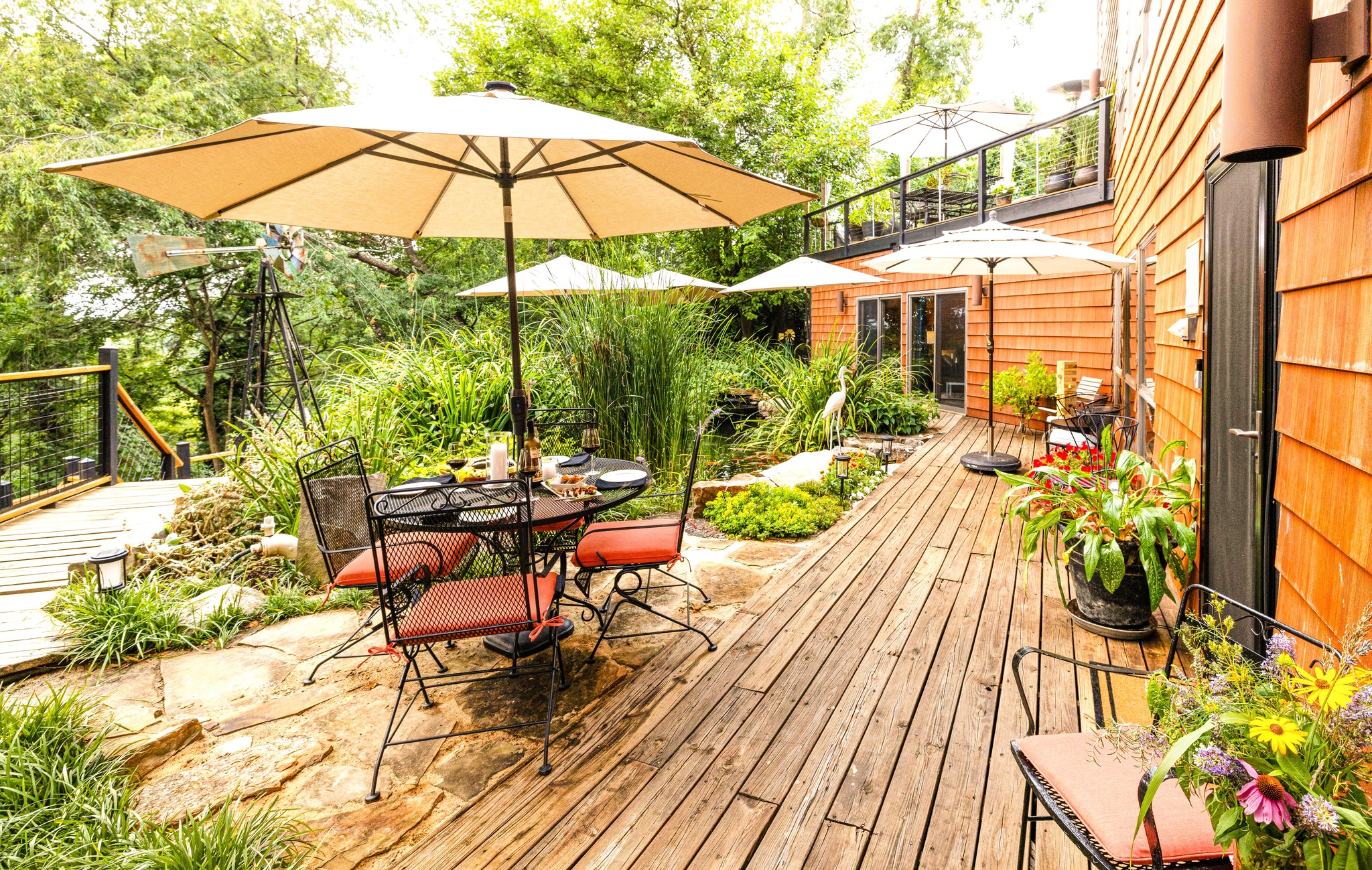 Outdoor deck and al fresco dining area at Hilltop Oasis Abingdon vacation rental in Abingdon, Virginia. Dine outside surrounded by gardens, the koi pond and Henrietta Heron guarding the fish. Have fun watching and feeding the Koi - they love watching you.