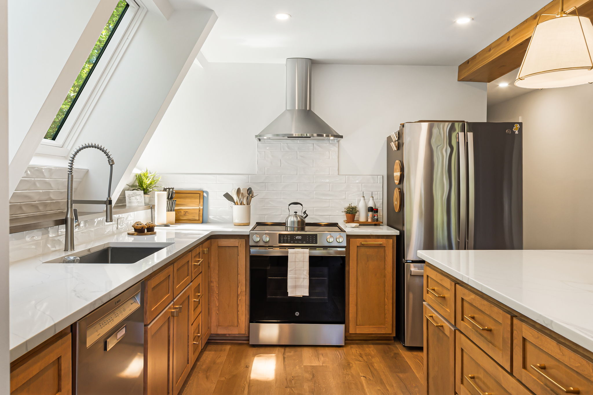 Beautifully designed kitchen combines warmth and functionality with modern style. A spacious center island with seating for 4 is perfect for casual meals or morning coffee. Experience convenience with a microwave drawer on the island and a Bosch dishwasher