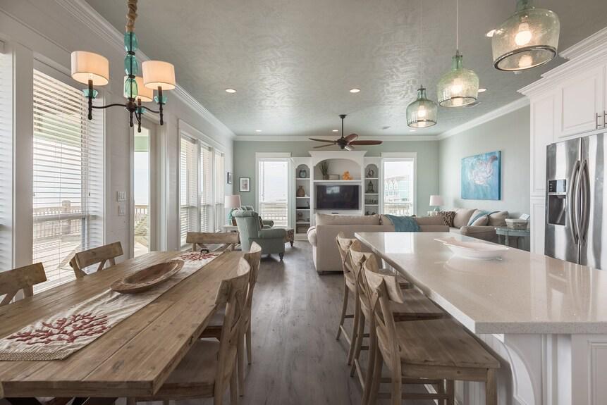 Whether you’re cooking up a feast or chatting with guests, this airy kitchen offers a perfect flow from the dining area to the living room, filled with light and charm.