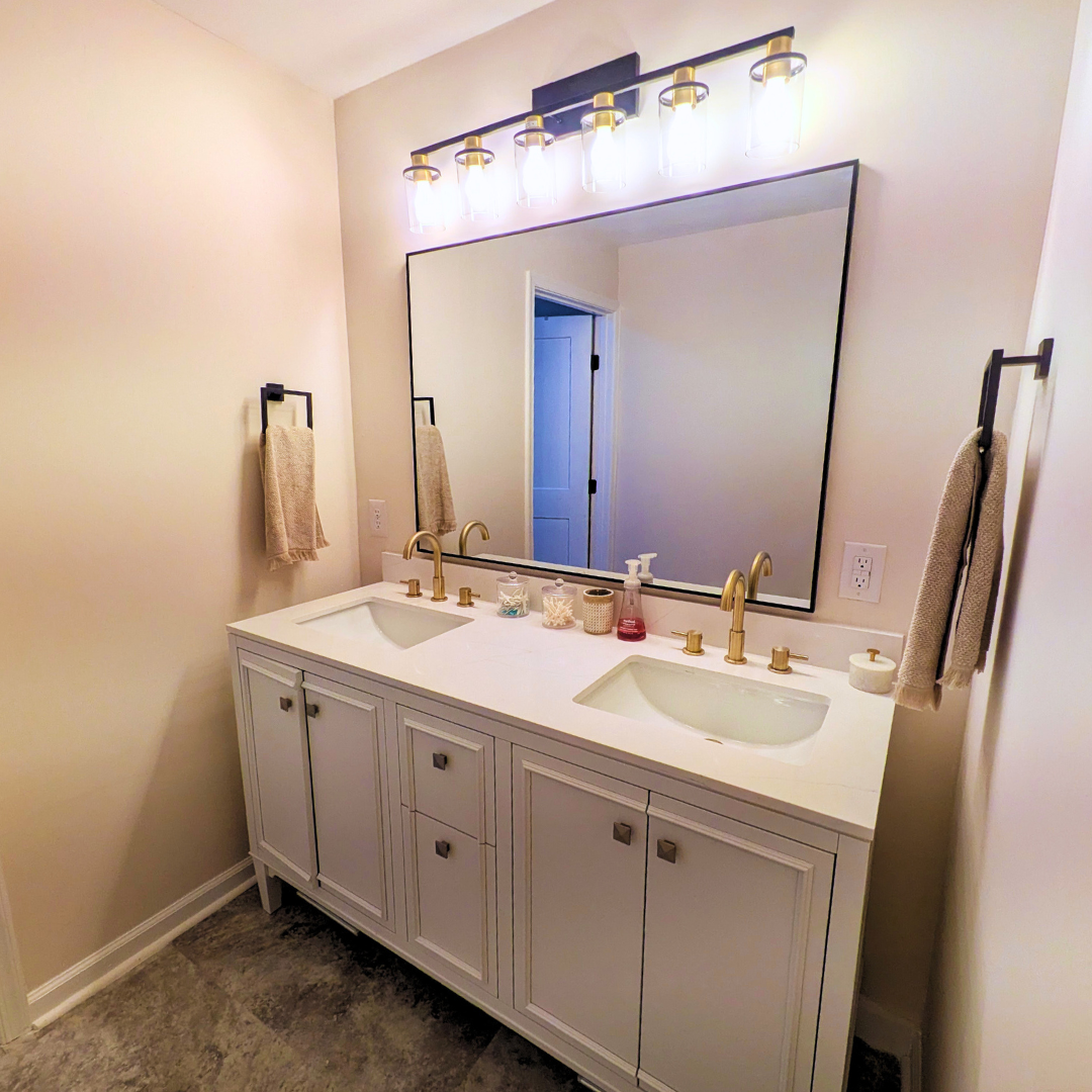 Vanity area with mirror and lighting, perfect for getting ready before heading out.