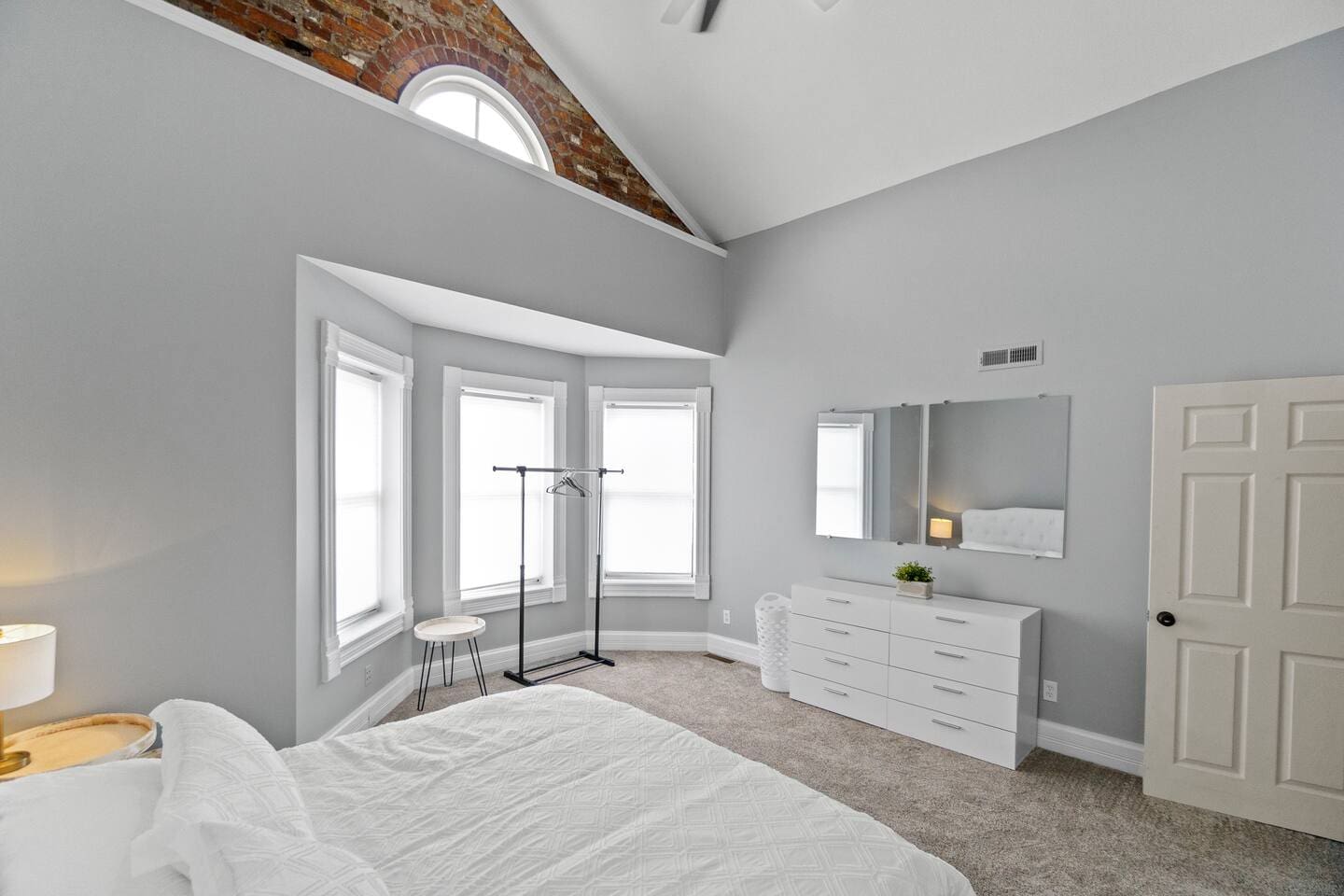 Cozy view from the king-sized bed, showcasing the serene ambiance of the room with its spacious, clean white interior and calming atmosphere.