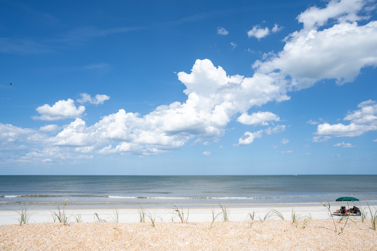 And this is what you came for: wide, quiet sand, sea oats along the dune line, and space to set a chair down without anybody pitching up beside you. Some mornings out here you will have most of it to yourself.