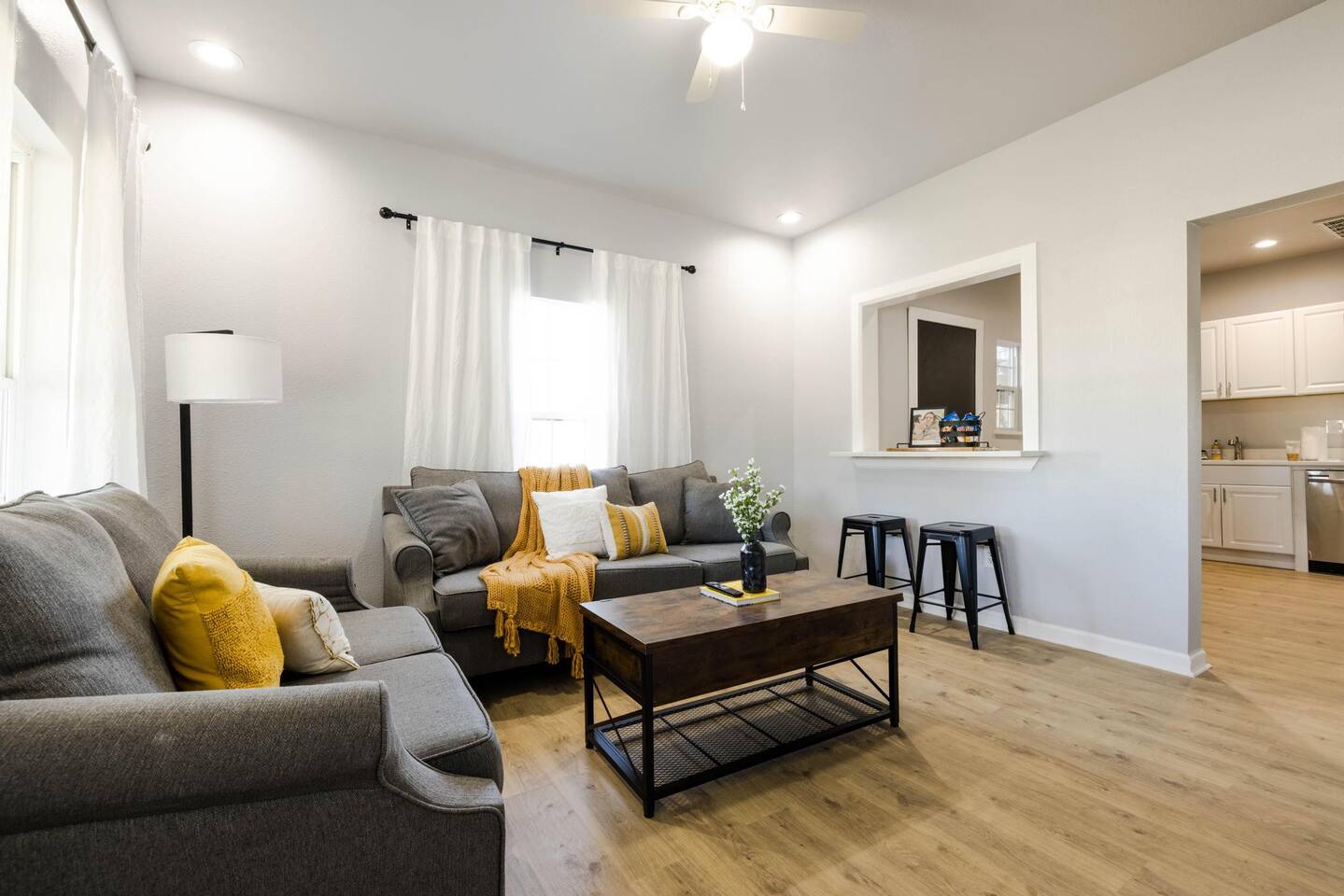 Enjoy this open-concept living room designed for comfort and relaxation, featuring stylish decor and ample seating.