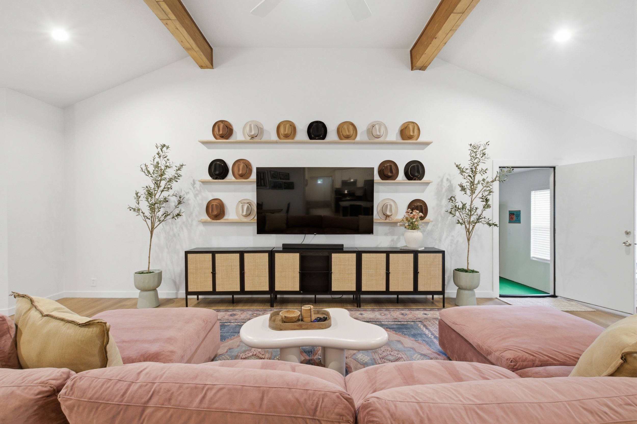 Living room wide-angle with 75" Smart TV and open sightlines to dining area. High-speed Wi-Fi and Private Living Room for exclusive guest use.