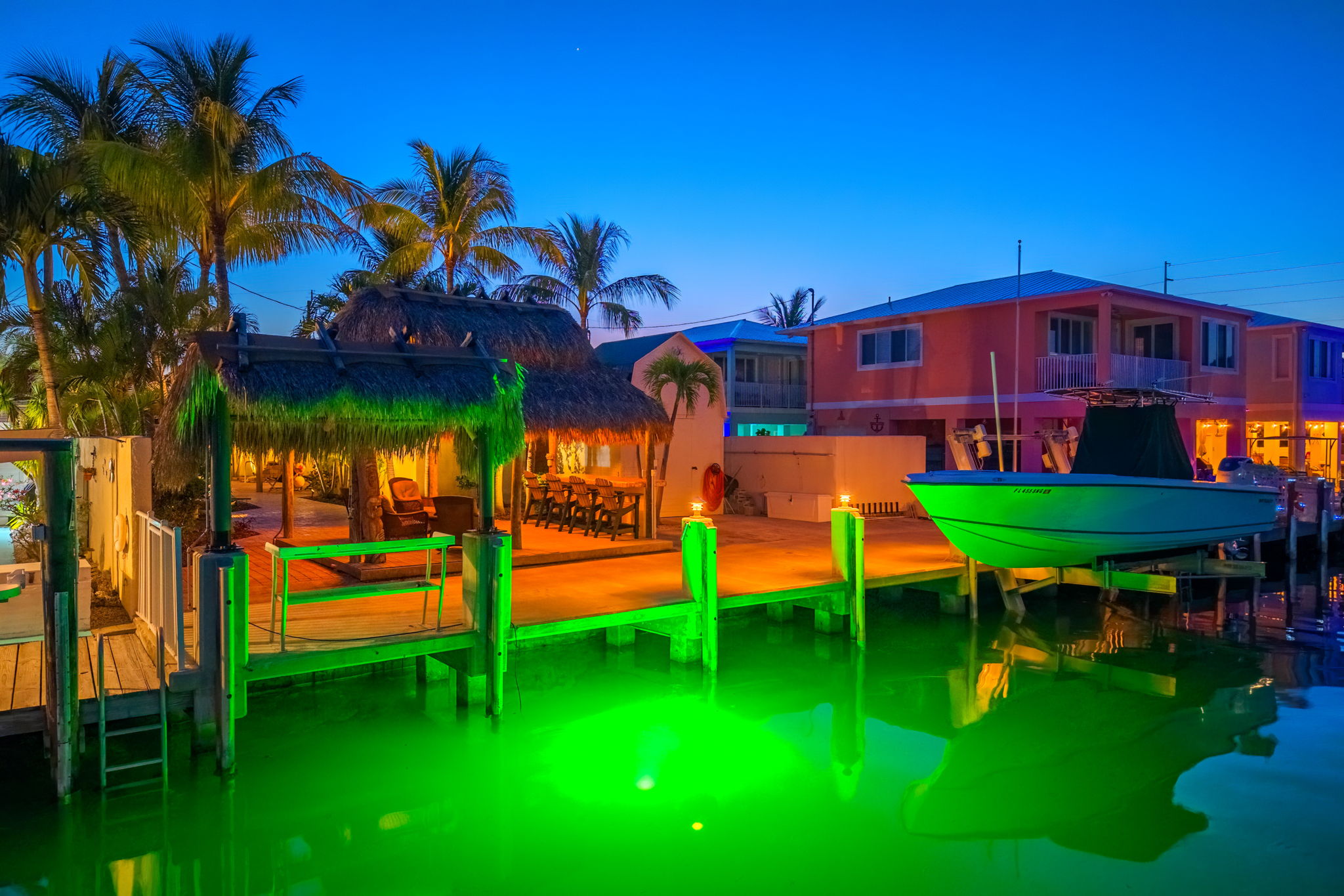 Underwater lights bring fish into the dock in the canal at night.