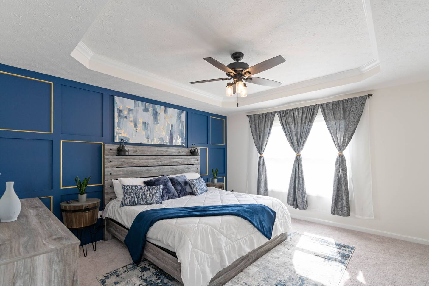 master bedroom featuring king size bed, tv, walk in closet, and private bathroom