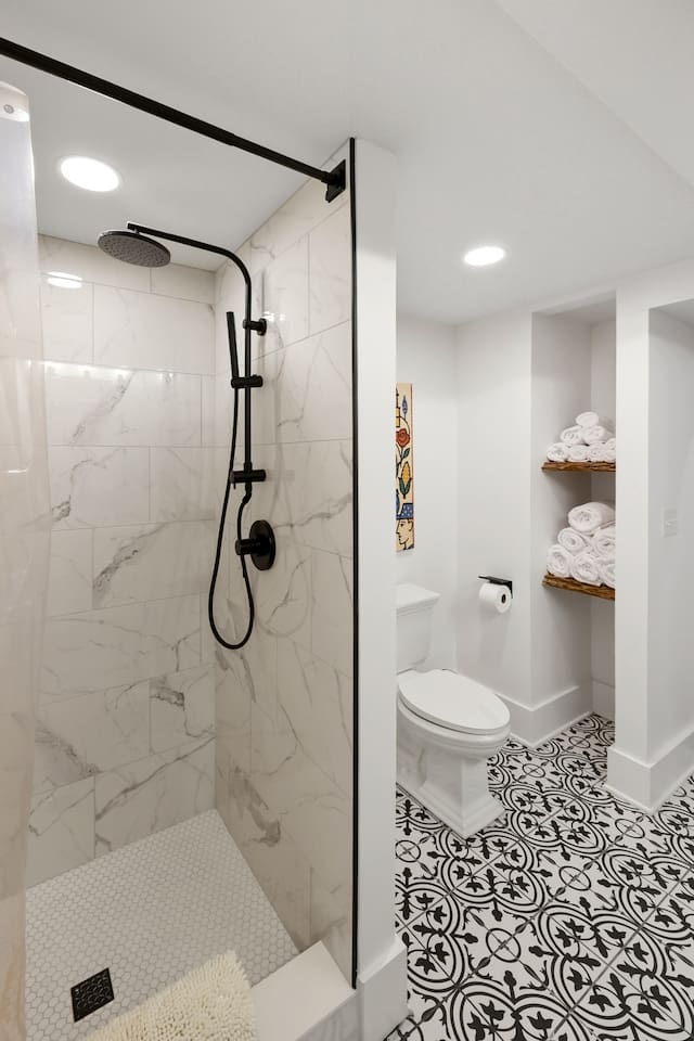 Spacious full bath with double vanity and tile shower. 