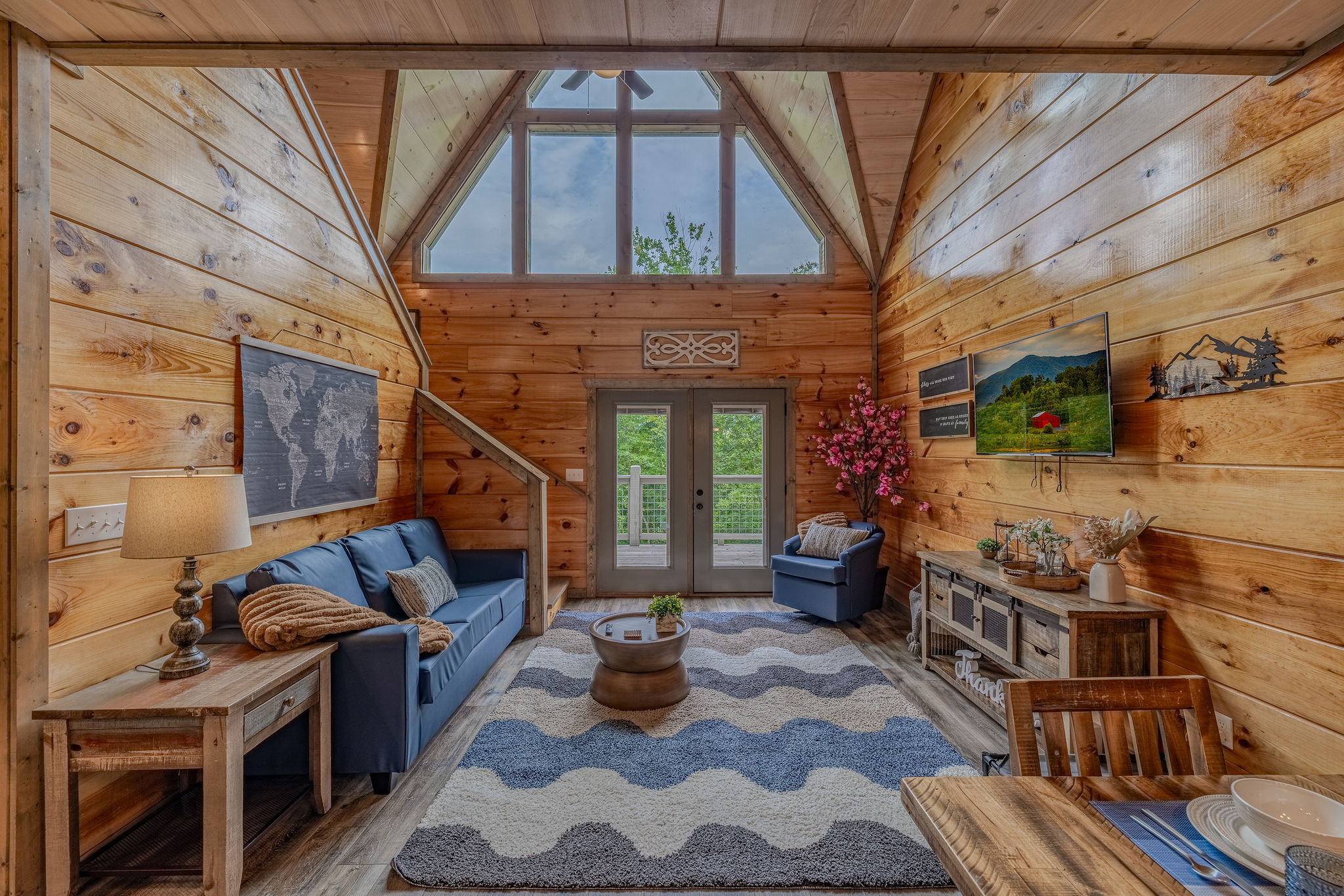 The Collector’s Gallery is the main gathering space, with warm cabin style, comfortable seating, and room to relax together.