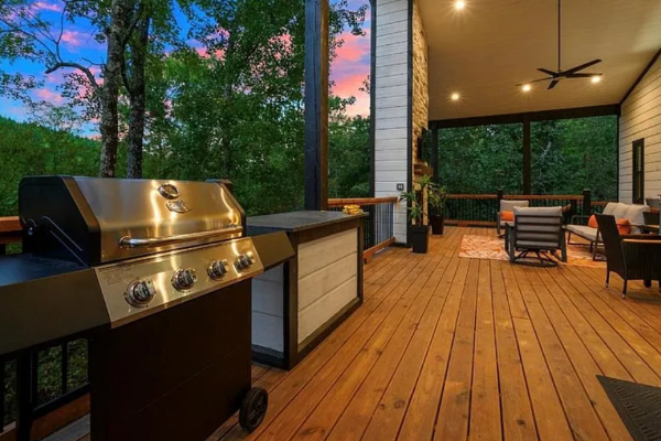 Spacious outdoor deck with grill and comfortable seating area.