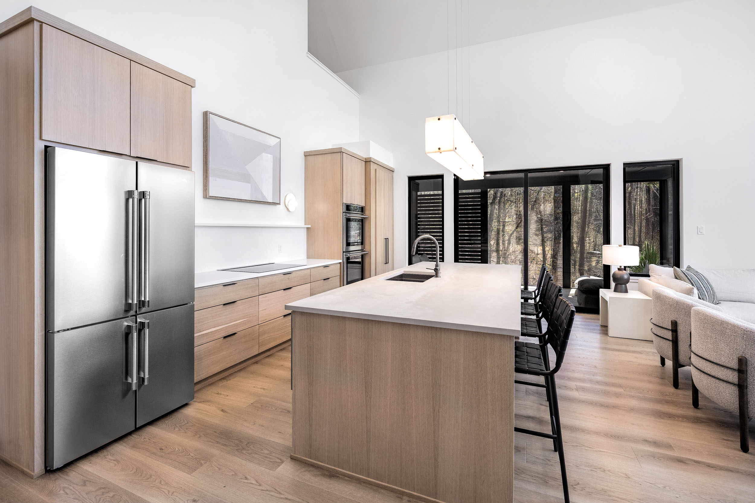 This sleek, modern kitchen is fully equipped with high-end appliances and spacious countertops for preparing group meals with ease. 