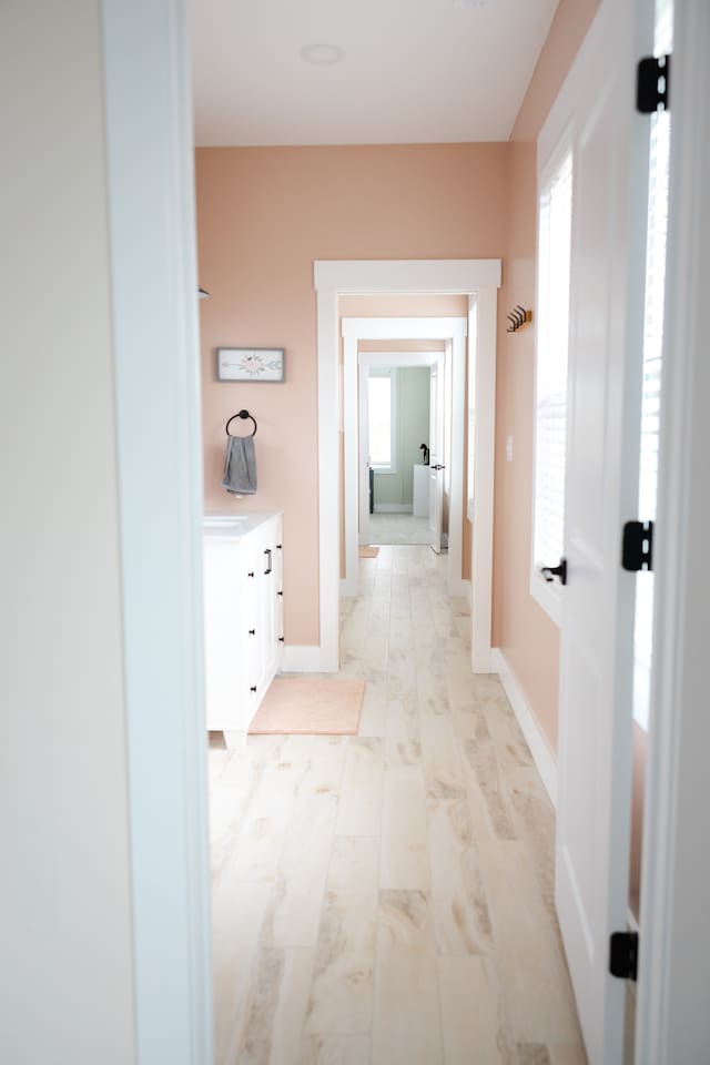 View from doorway of bedroom #4 looking through private vanity/sink area to bedroom #5. Two sliding doors and two regular doors (plus privacy doors on toilet and shower areas) provide the option for privacy between these two rooms. 