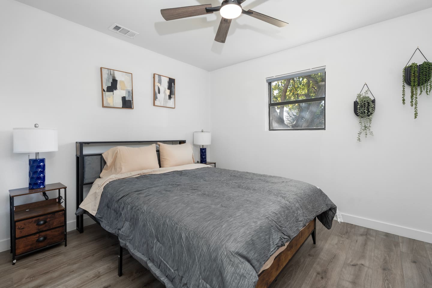 A calm and comfortable room featuring a queen bed, ceiling fan, and crisp bed linens. Ideal for a restful night after enjoying Grand Prairie and Greater DFW!