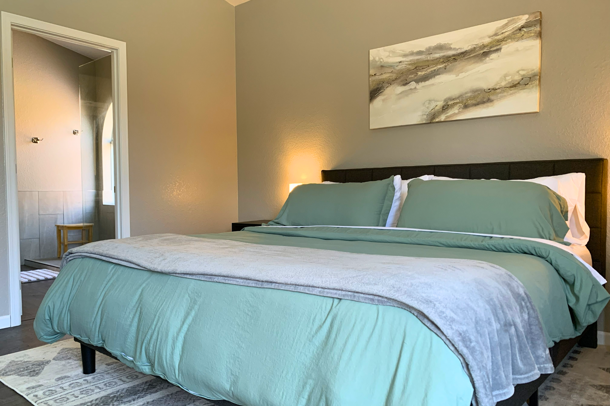 Ensuite bathroom off the primary bedroom with walk-in shower, robes, and soft natural light for a spa-like feel. 