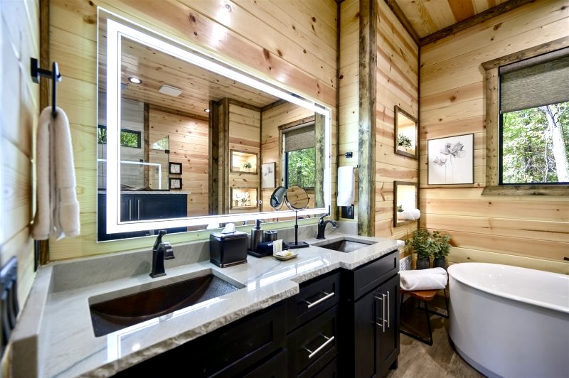 This spacious ensuite features a walk-in shower, soaking tub, and high-end finishes