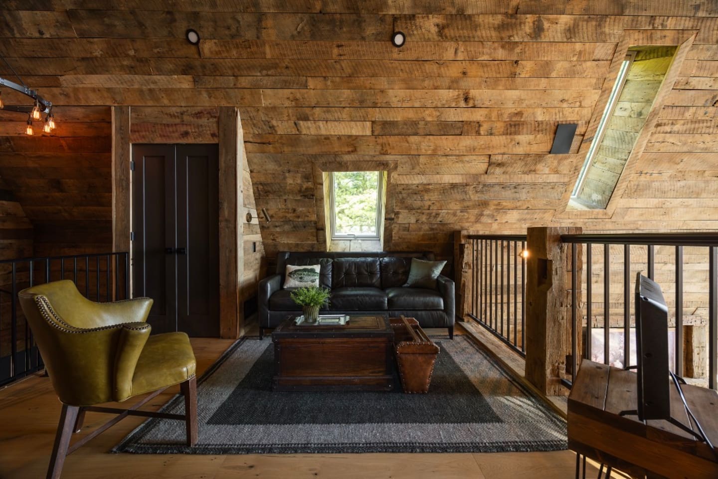 Open loft-style bedroom with private twin-over-queen sleeping area. 
