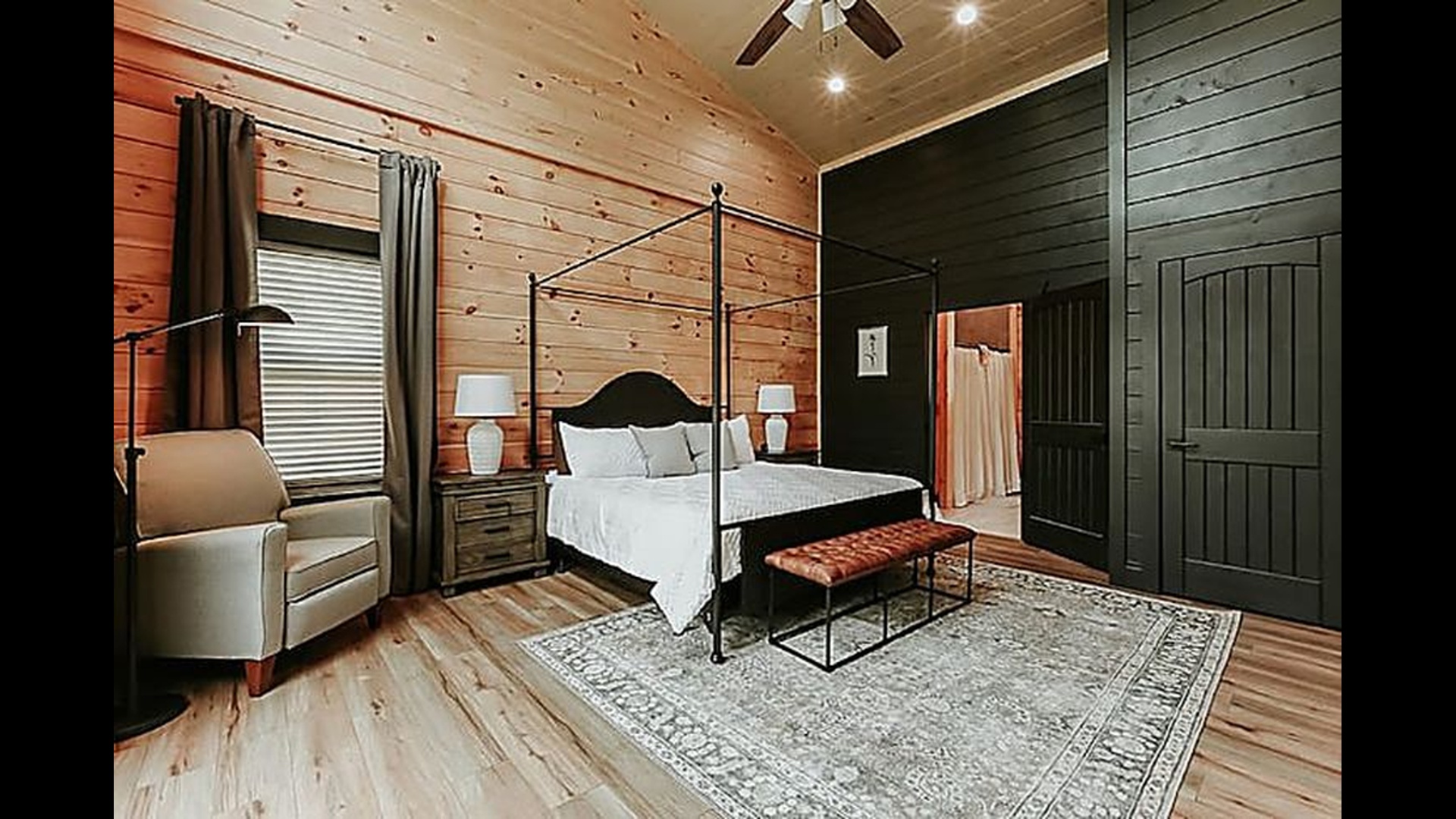 Fall asleep beneath cozy canopy linens and wake to the peaceful glow of the mountains