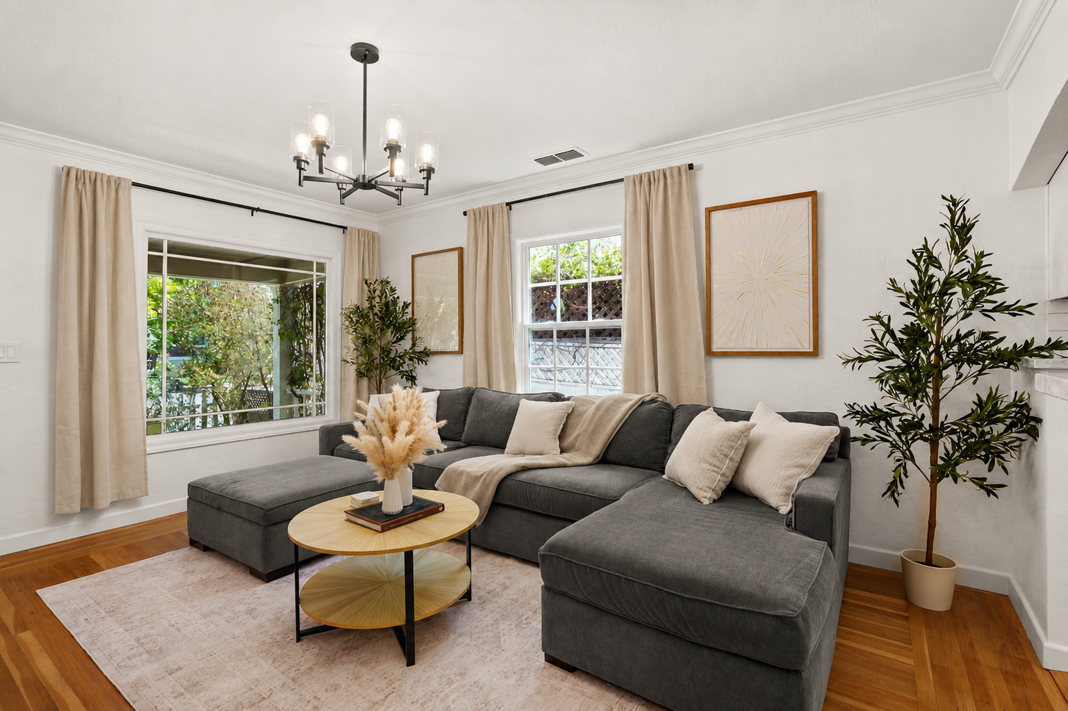 Bright, inviting living room with cozy seating, modern decor, natural light, and a Smart TV for relaxing nights in.
