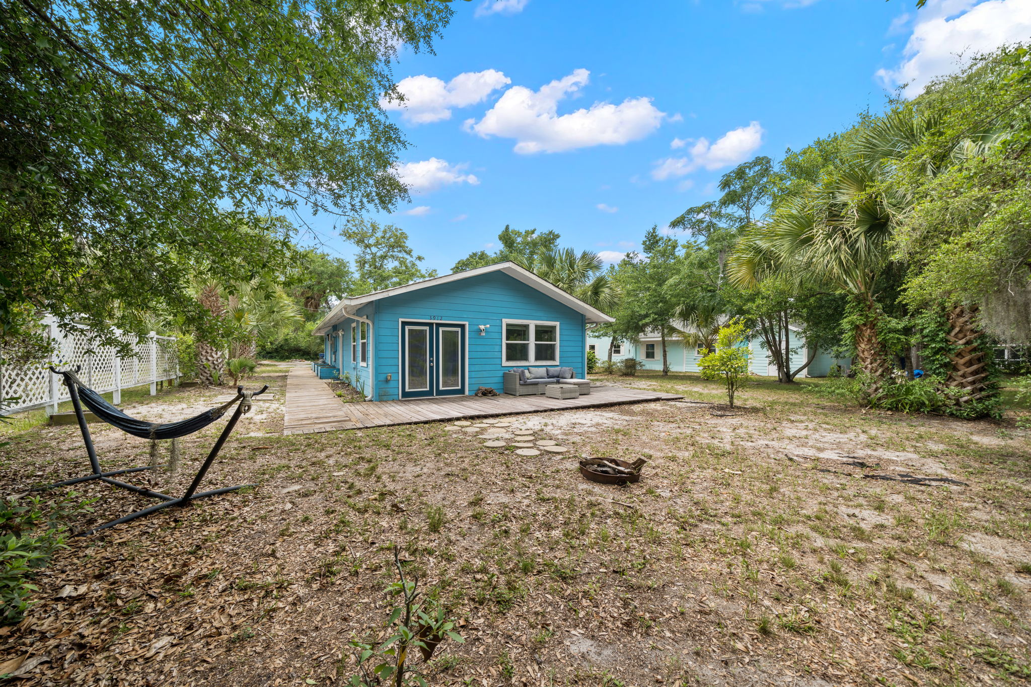 Spacious private backyard with hammock, fire pit, and room to relax