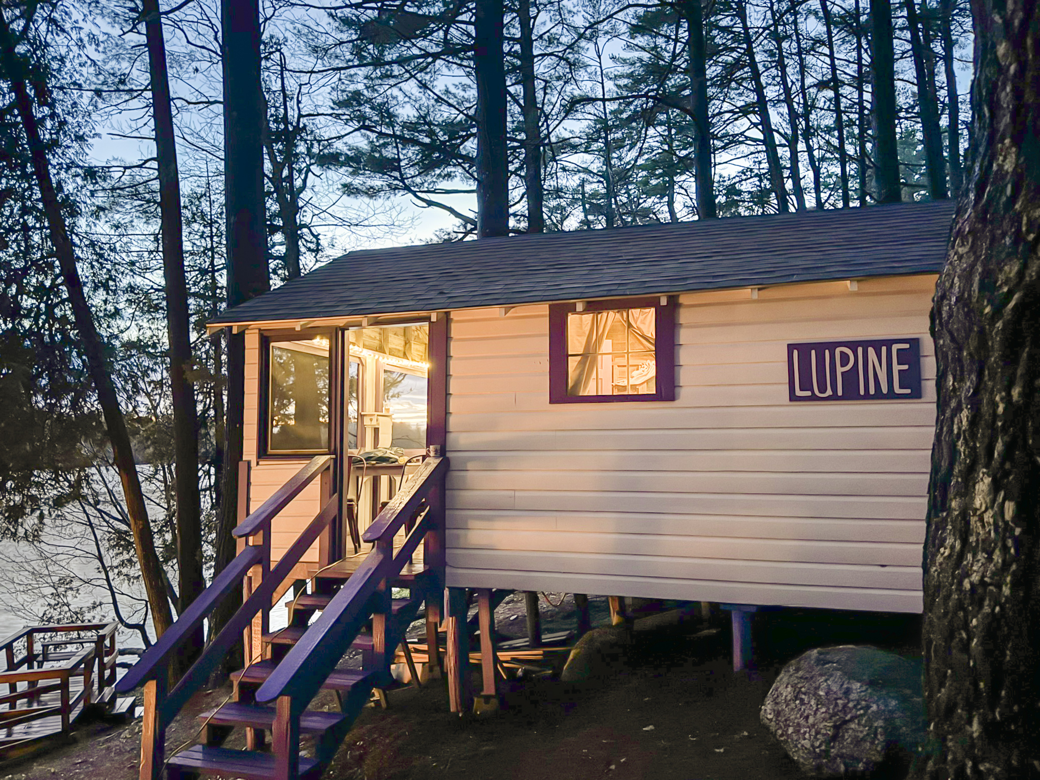 Exterior of the cabin in the woods with sunset