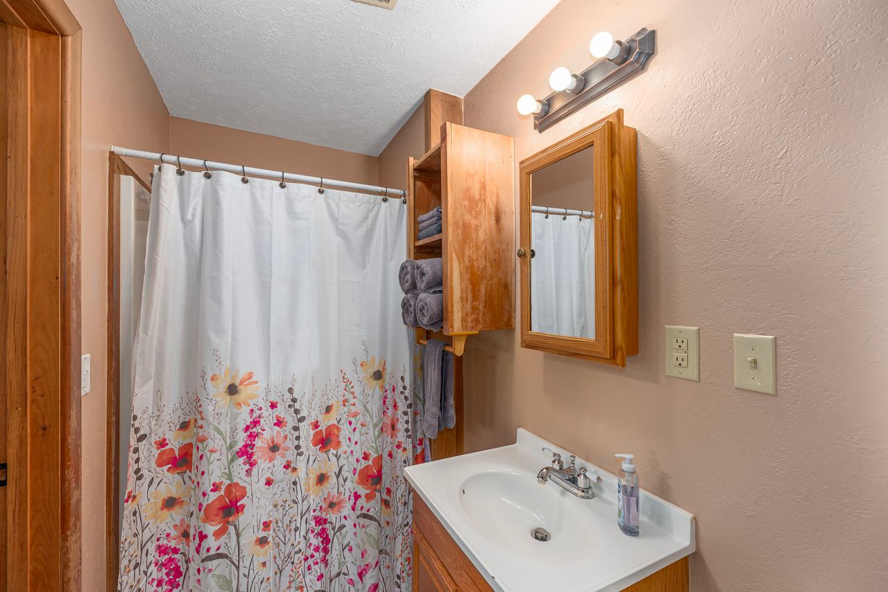 The downstairs of the cabin has a full bathroom with a walk in shower. 