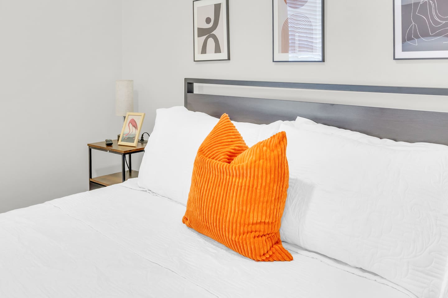 Bedroom with cozy queen bed, plush bedding and fresh decor.