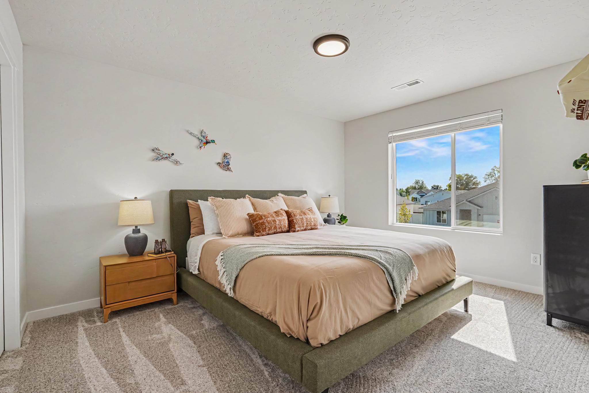 One of the spacious upstairs bedrooms features a comfortable California king-size bed and plenty of room to relax, unwind, and enjoy a restful stay.