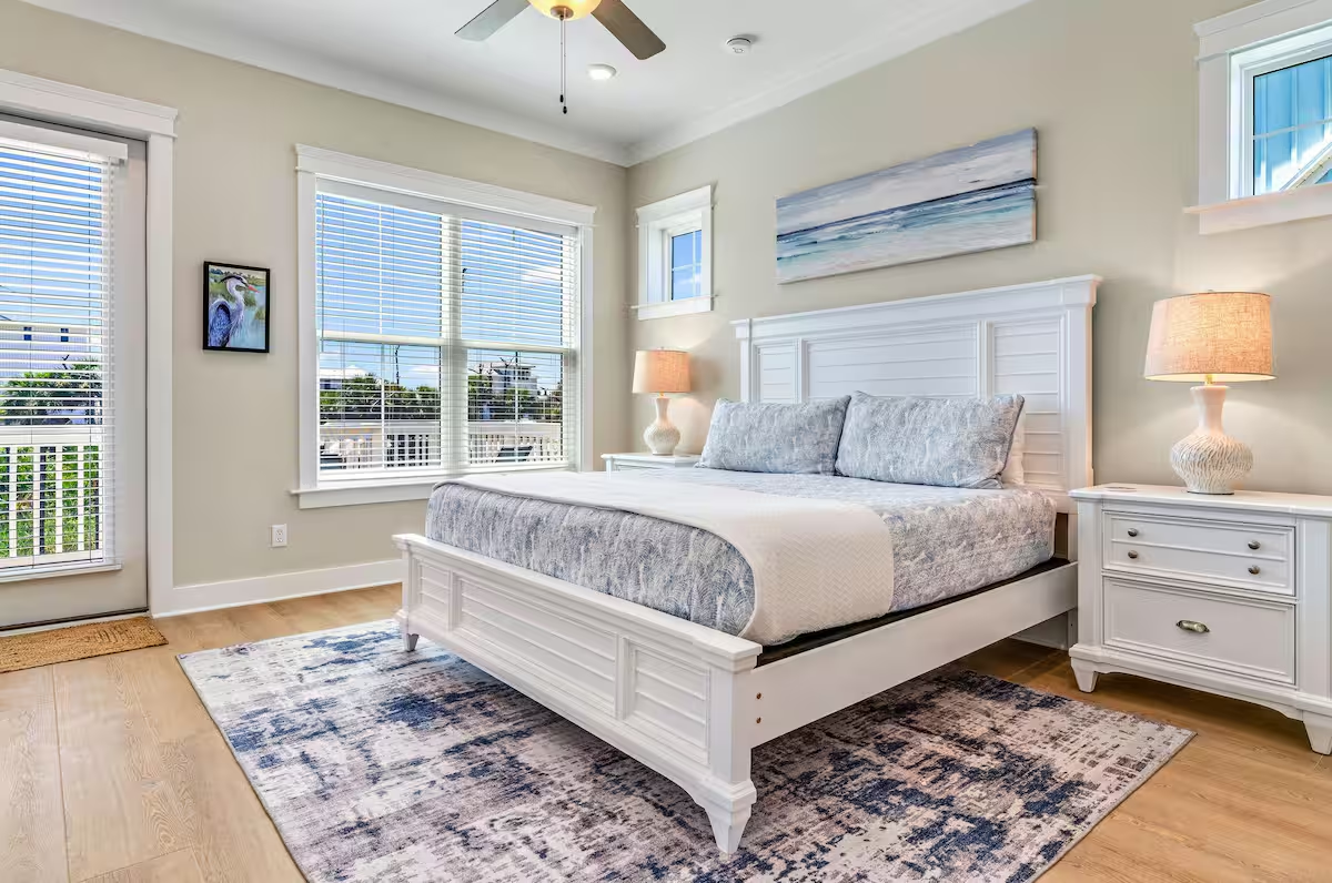 The first-floor king primary suite features a private coffee bar, mini fridge, attached spa-style bath, balcony access, and a 50" Roku TV. Every bedroom includes its own 50" Roku television for ultimate comfort and entertainment.