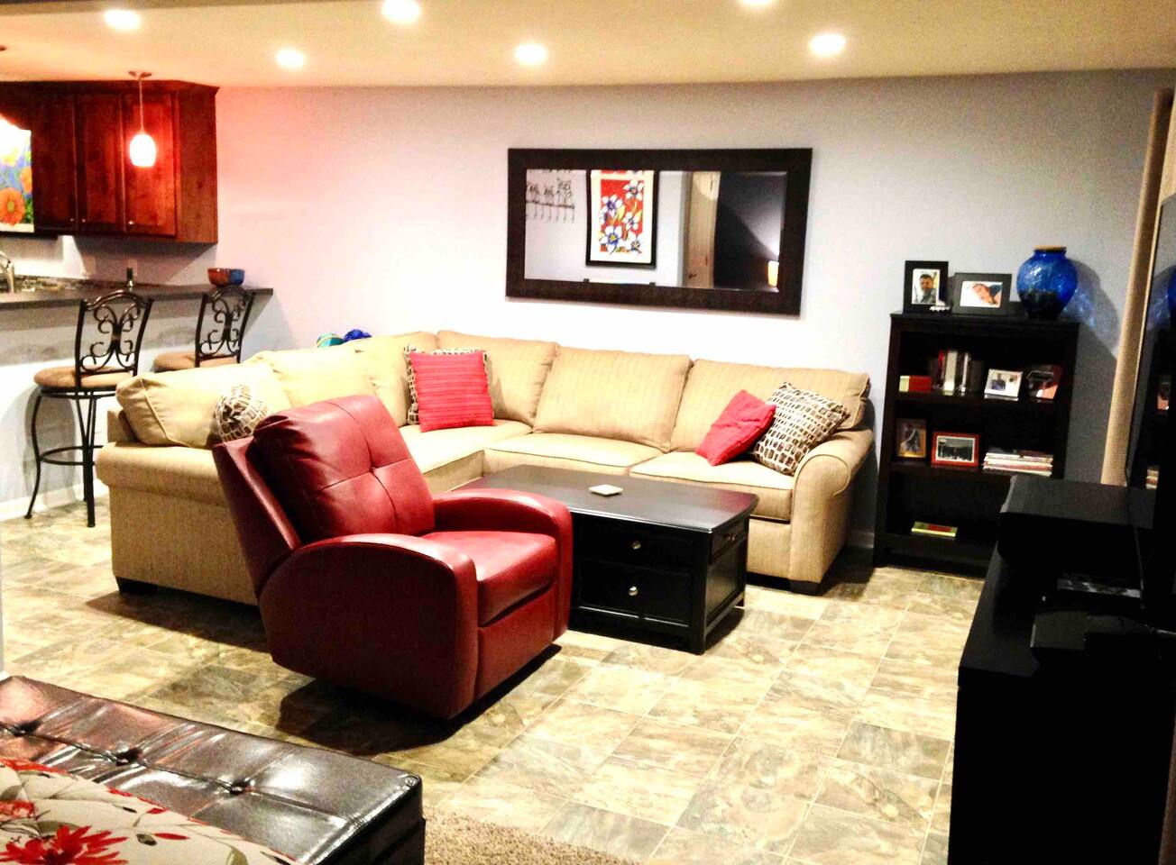 Large sectional couch with red recliner. Coffee table lifts up create a table height or comfortable office workspace if you have to work while on vacation. 